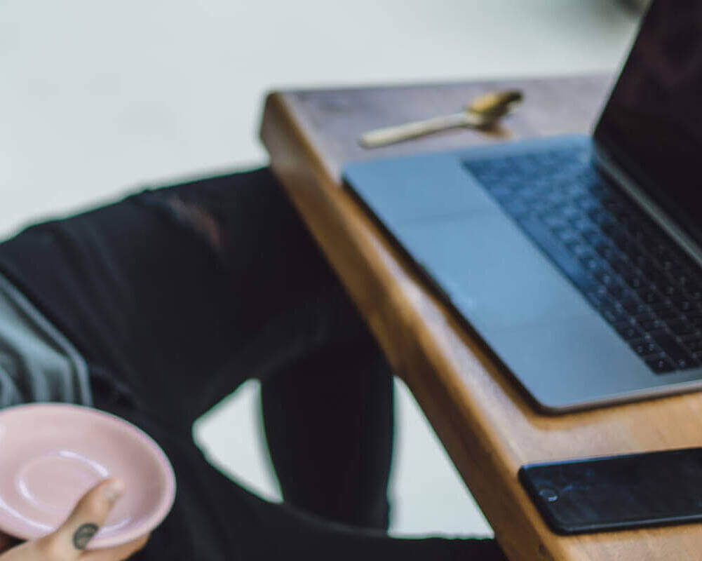 Man Is Working In A Cafe. Concept Of Freelancing, Coffee And Lap